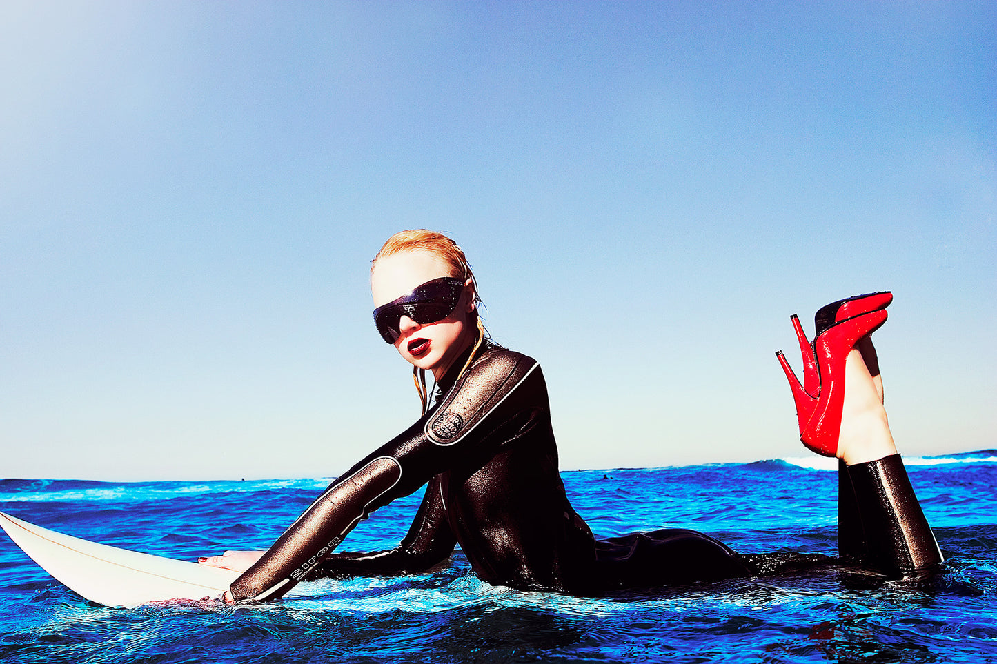 KaneSkennar-Girl in Red high heels laying on surfboard